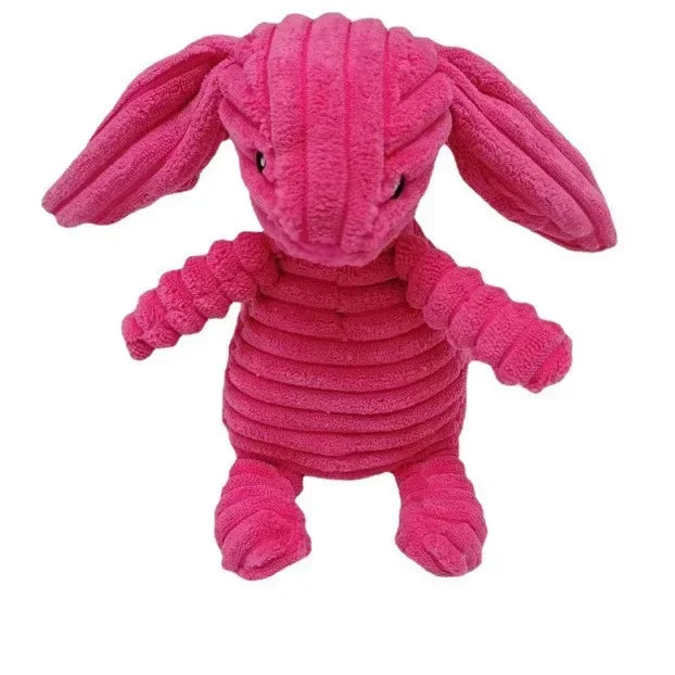 A pink corduroy squeaky dog toy shaped like an elephant with long ears.