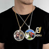 A man wearing a black t-shirt displays a custom photo pendant necklace with 18k gold finish featuring two people.
