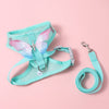 A light blue butterfly pet harness set for dogs and cats displayed on a pink background.