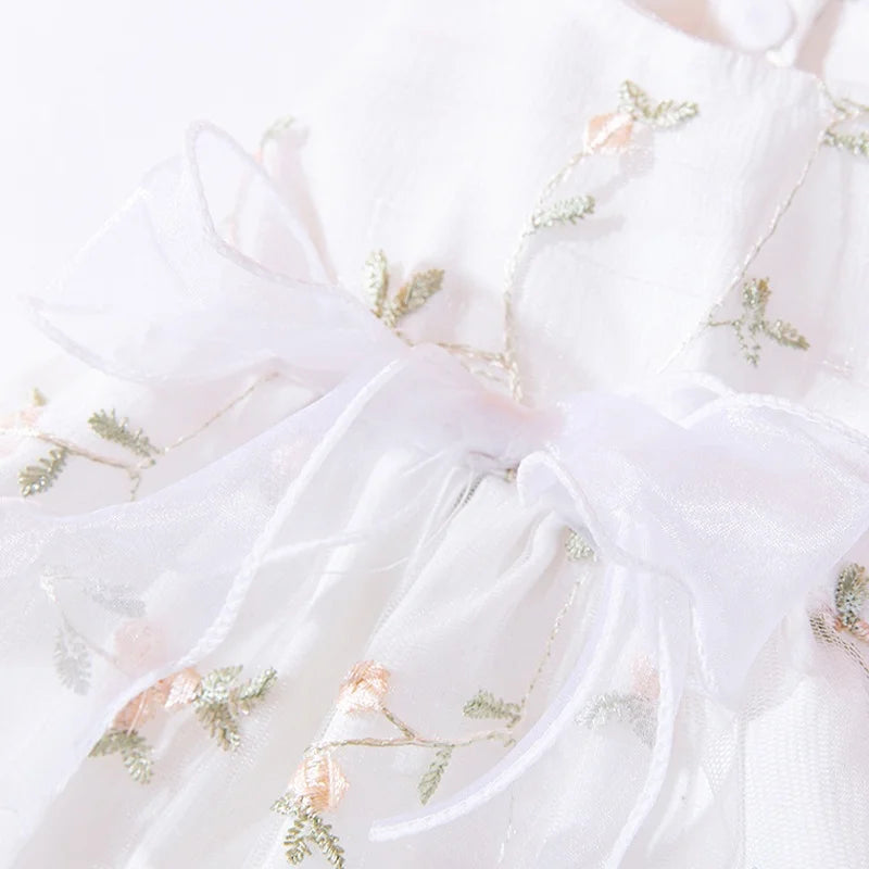 White sheer dress for a dog featuring floral embroidery and a bow detail