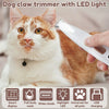 A cat is being groomed with a handheld pet hair trimmer featuring an LED light and various attachments.