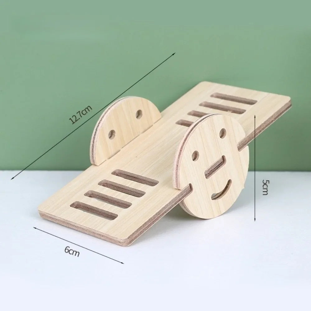 A natural wooden hamster house and activity platform with various openings and a smiling face design.