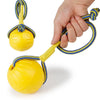 A hand is holding a yellow rubber fetch ball with blue braided rope attached.