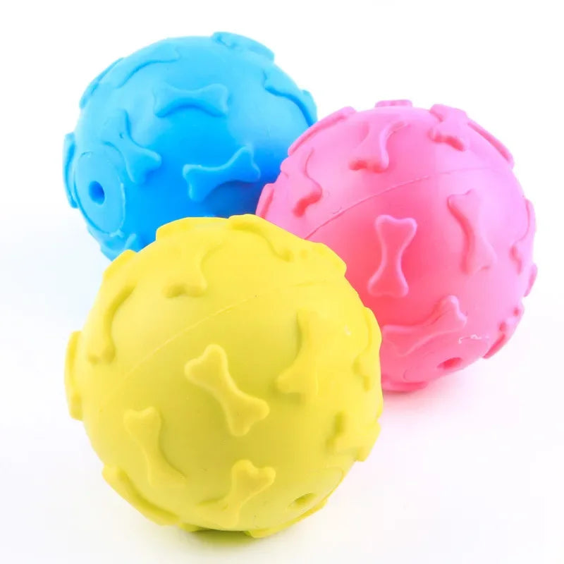 Three brightly colored rubber chew toys for small dogs: blue, pink, and yellow.
