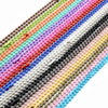 A close-up of a colorful plated ball bead necklace set featuring various shades of pink, purple, green, and gold beads.
