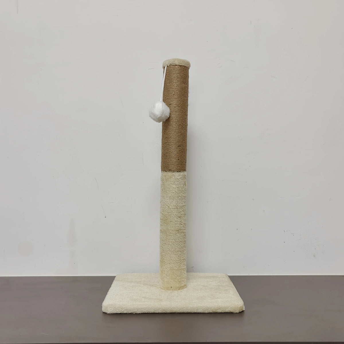 A minimalist sisal cat scratching post with a cylindrical wooden column and a flat base.