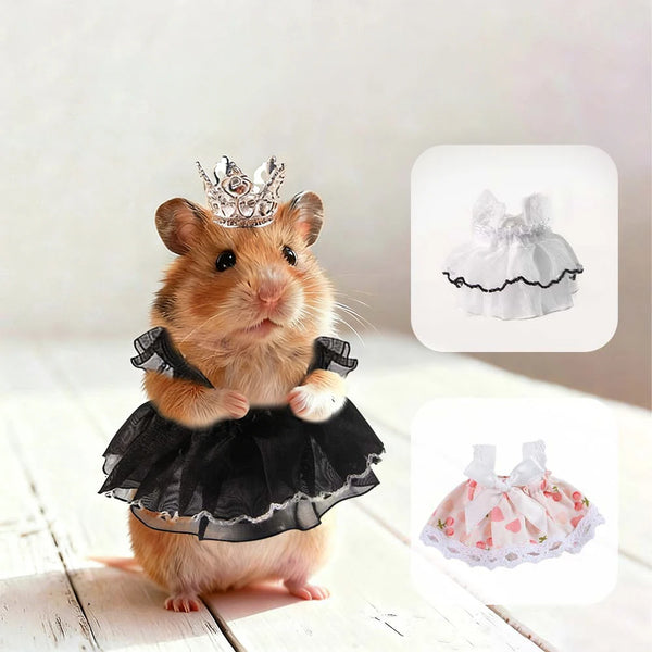 A fluffy brown hamster wearing a black lace dress and a small silver crown.