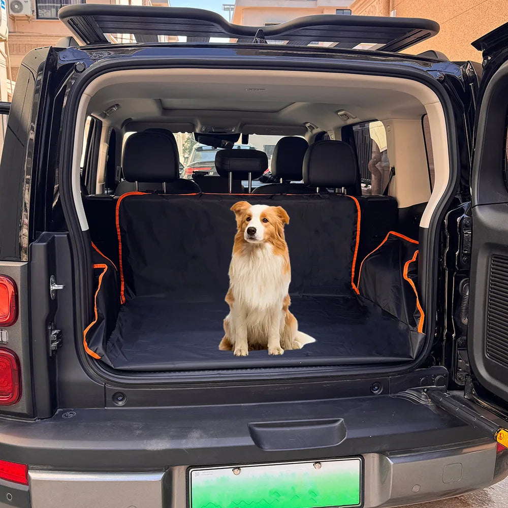 A golden retriever sits inside the open cargo area of a black SUV with an orange pet seat cover installed.