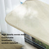 A beige high density woven mesh suction cup hammock for a windowsill or glass surface.
