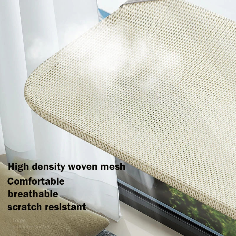 A beige high density woven mesh suction cup hammock for a windowsill or glass surface.