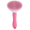 A pink pet hair remover grooming brush with a textured silicone head and a pink handle.