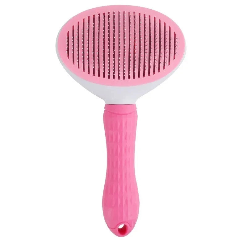 A pink pet hair remover grooming brush with a textured silicone head and a pink handle.