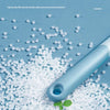 A light blue silicone shower squeegee is shown resting on a pile of white, irregular silicone material.