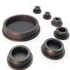 A set of dark gray silicone rubber hole plugs and caps of various sizes arranged on a white background.