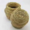 A tightly woven natural straw bird nest for pet avians.
