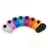 A row of ten colorful plastic pet training clickers in various shades including blue, purple, orange, and gray.