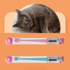 A gray cat is shown next to two silicone pet toothbrushes, one pink and one teal.