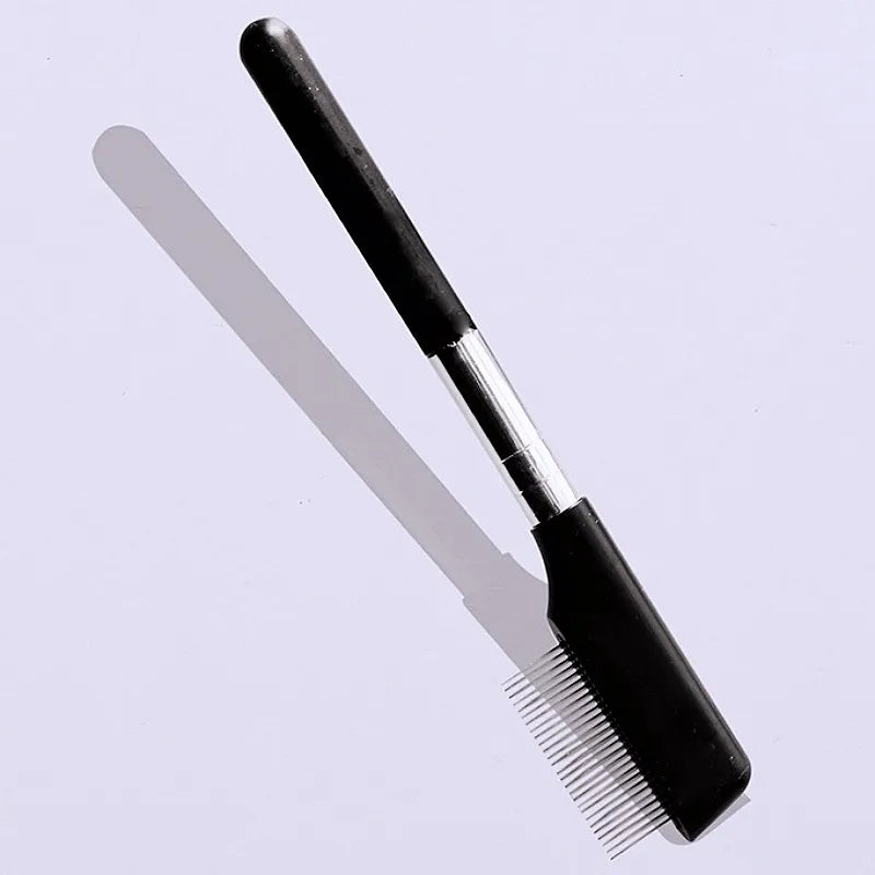 A black pet face comb with fine teeth is shown against a light background.