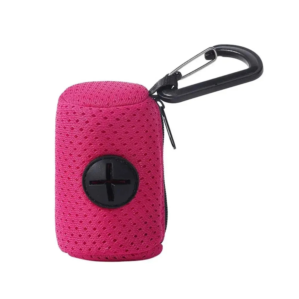 A pink portable mesh dog waste bag dispenser with a black clip.