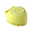 A yellow silicone pet bath massage brush with a foam maker attachment.
