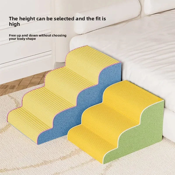 Yellow and blue foam puppy stairs and ramps placed on a light carpet next to a white bed.