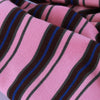 Close-up of a pink and brown striped knitted fabric, likely a pet jumpsuit.