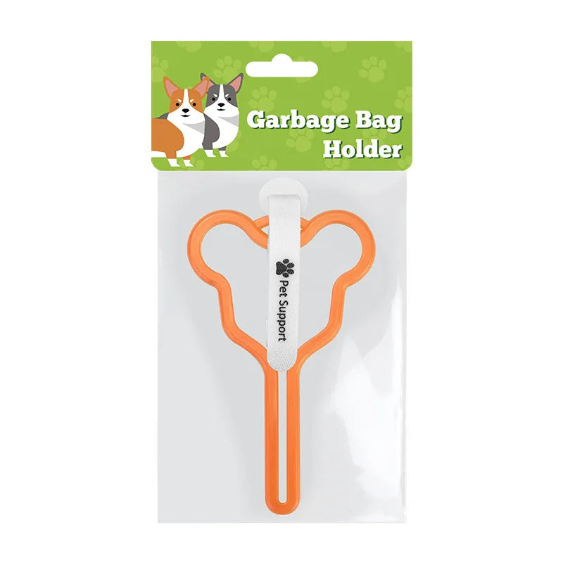 A clear plastic package containing an orange hands-free dog poop bag holder with a leash clip and a green cardboard label.