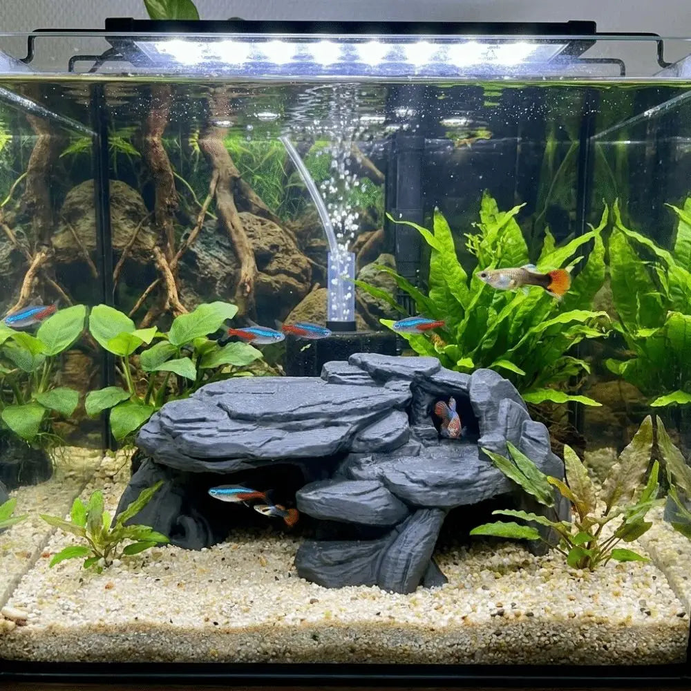 A realistic 3D printed fish tank rockery ornament featuring rocks and aquatic plants.