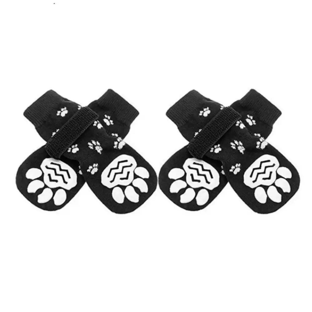 Pair of black and white breathable anti-slip dog socks with paw print patterns