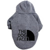 A gray cozy fleece dog hoodie with a hood and the text THE DOG FACED printed on the back.