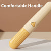 A close-up view of a beige pet brush with a comfortable handle and massage pins.