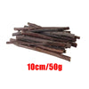 A pile of dark brown wooden chew sticks, 10cm long and weighing 50g.