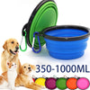 A green and blue silicone pet feeder bowl with carabiner clips and various colored silicone feeders.