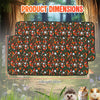A rectangular reusable absorbent cage liner patterned with small animals and foliage, shown in a natural outdoor setting.