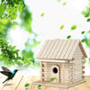 A wooden birdhouse with a pitched roof and entrance is shown outdoors against a bright, leafy green background.