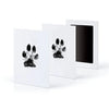 A set of three white framed prints featuring black paw print designs for pet keepsakes.