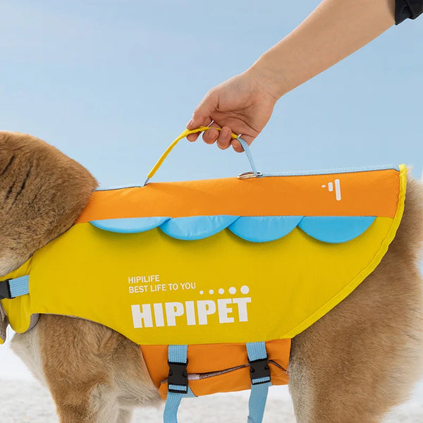 A dog is wearing a bright yellow and orange life jacket for summer swimming.