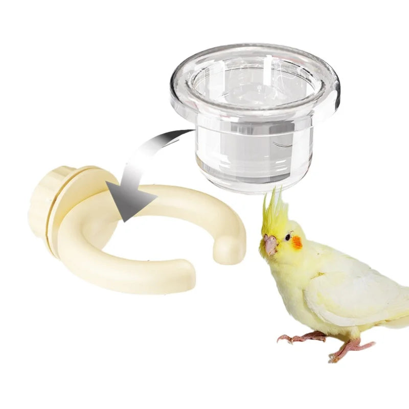 A transparent hanging bird feeder box with a detachable design next to a small yellow bird.