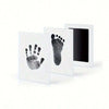 A set of three framed prints showing black ink pet paw prints on white paper.