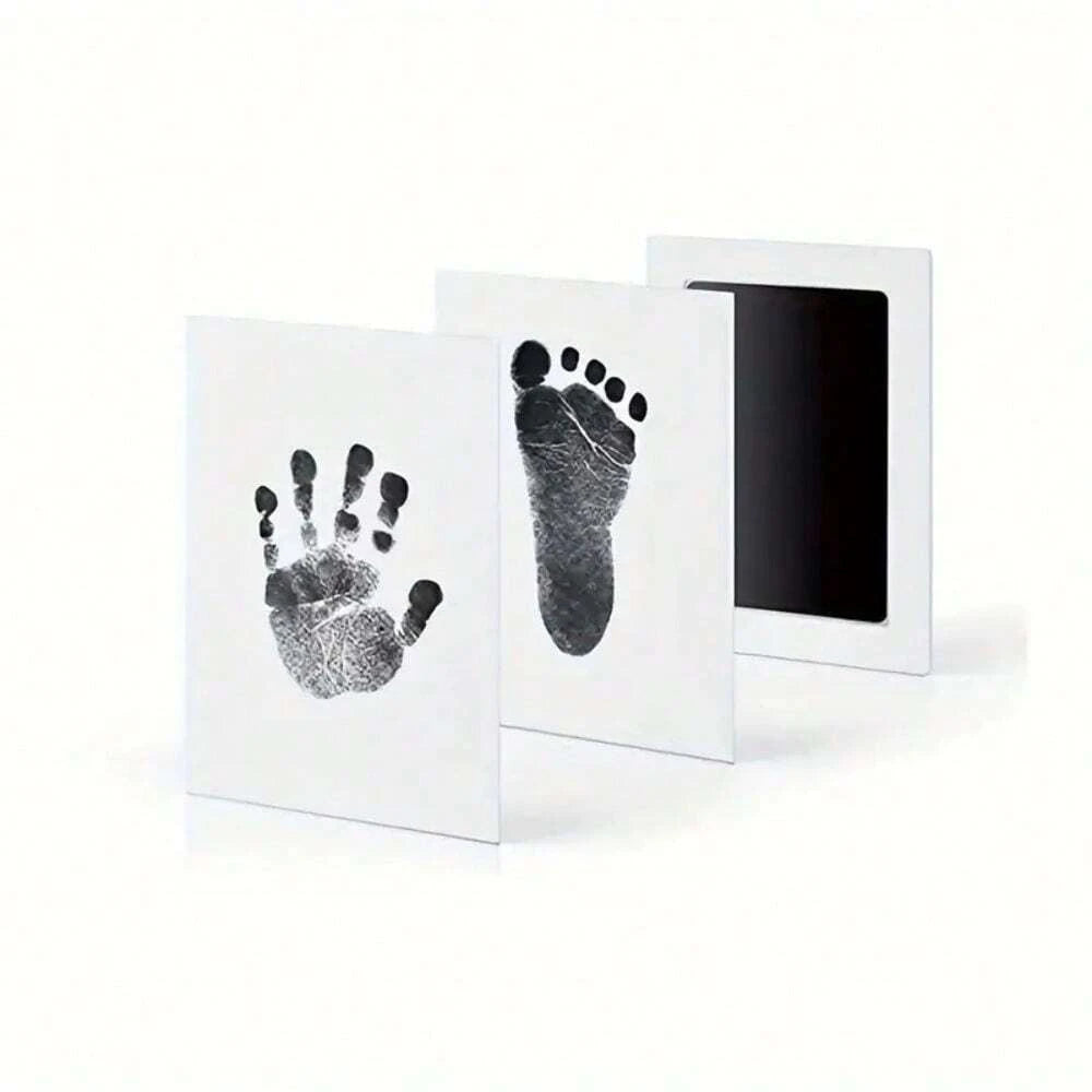 A set of three framed prints showing black ink pet paw prints on white paper.