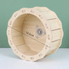 A natural wooden hamster house and activity platform with a circular opening and wooden slats.