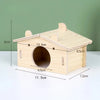 A light wood hamster house with an entrance hole and a slanted roof, shown from above.