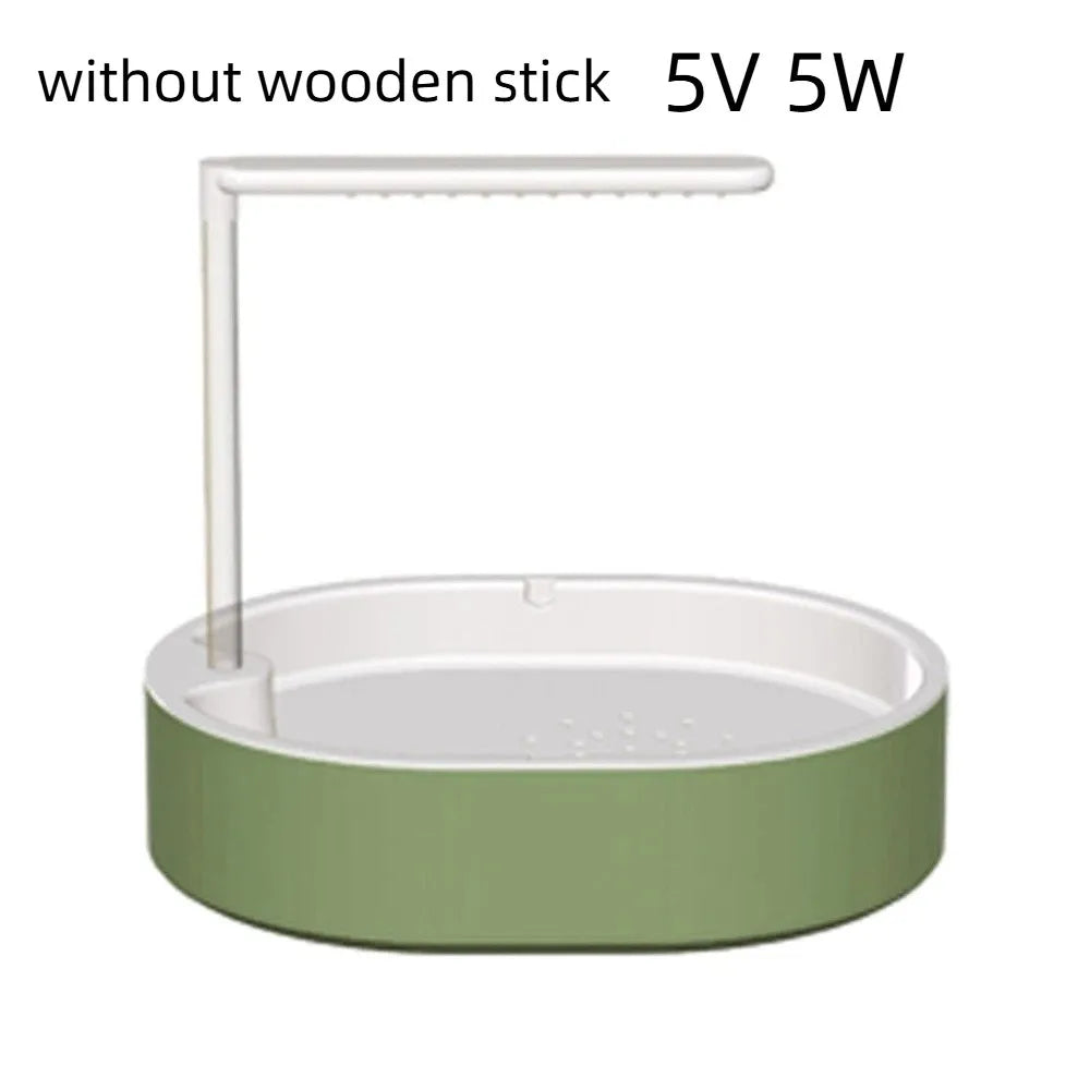 A white automatic bird bathtub with a resting stick, featuring a light green base.