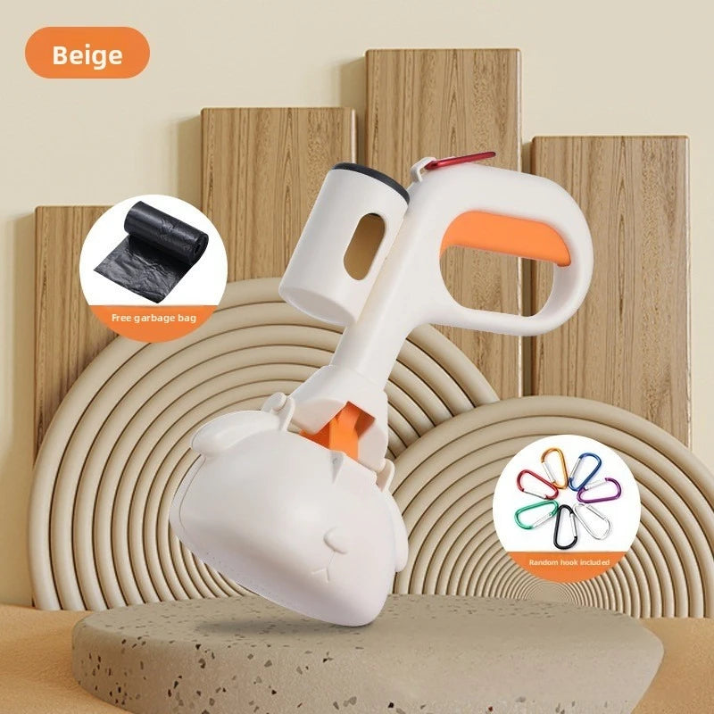 A white portable pet poop picker scooper with an ergonomic handle is shown on a beige surface.