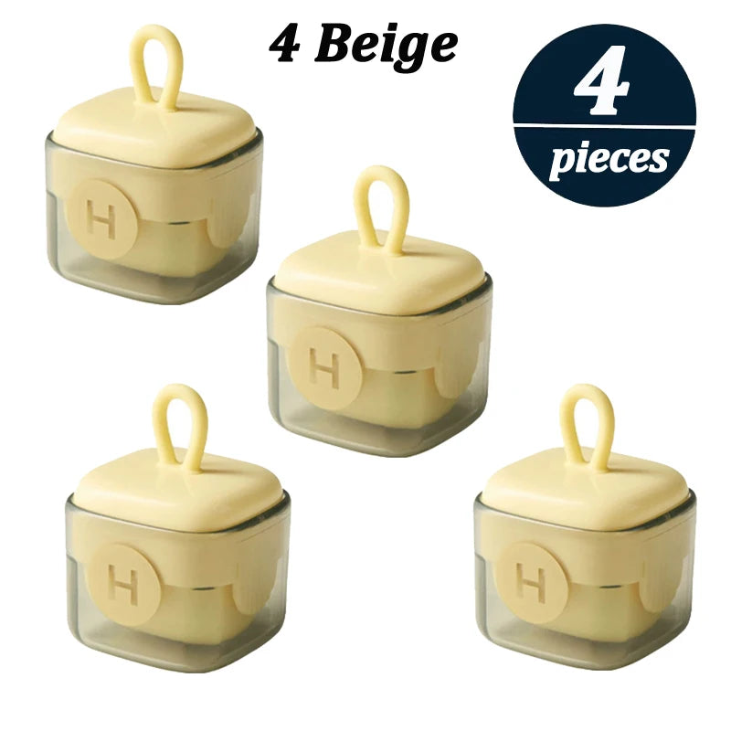 Vier beige wiederverwendbare Flusenentfernerrollen mit Griffen in einer klaren Dose.