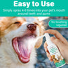 A hand is spraying a clear bottle of Pet Oral Freshening Spray for dogs and cats onto a dog's mouth.