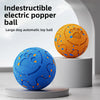 An orange and blue rubber electric popper ball toy for dogs displayed on a white stand.