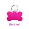 A bright pink bone-shaped dog ID tag with a silver keyring.