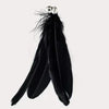 A black suction cup cat teaser wand with a replaceable feather toy.