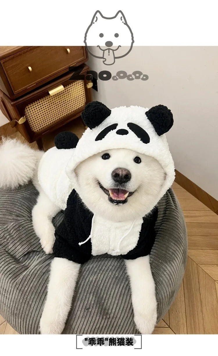 A white dog plush toy with a black panda face design wearing a black coat.